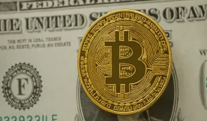 dollar background with bitcoin token on top