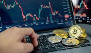Crypto Trading - Crypto Coins on a Laptop Showing Market Chart