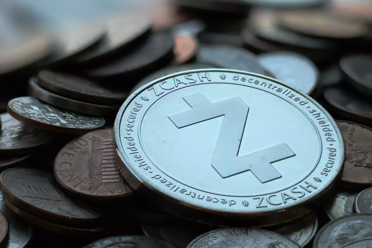 Physical Zcash (ZEC) coin resting on a pile of various coins.