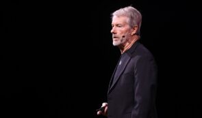 Strategy's Michael Saylor with a black suit giving a speech.