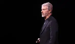 Strategy's Michael Saylor with a black suit giving a speech.