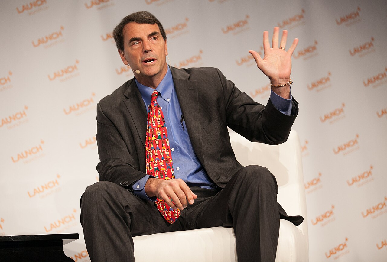 Tim Draper sitting on a chair and waving his hand during a conference Photograph: JD Lasica