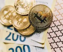 Bitcoin tokens on top of 200 euro banknotes