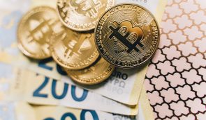 Bitcoin tokens on top of 200 euro banknotes