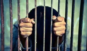 Person behind arrest bars