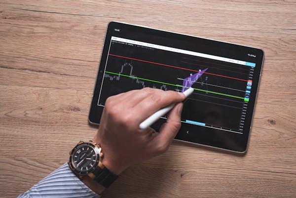Trader typin on touchscreen display