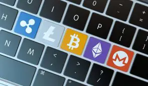 Macbook keyboard with altcoins logos