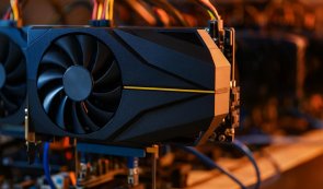 A cryptocurrency mining rig featuring a graphics card with visible cooling fans and connected cables.