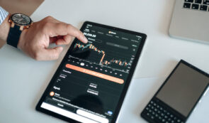 Trading charts on tablet, with person managing it