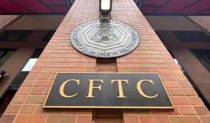 Exterior view of the Commodity Futures Trading Commission (CFTC) building showing the entrance sign and seal.
