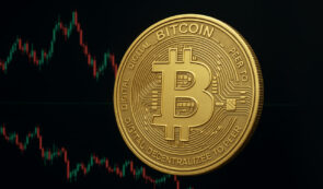 Bitcoin token and market chart in the background