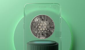 Cardano coin in glass panel on green background