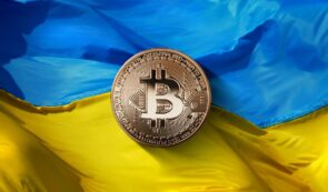 Bitcoin token on top of Ukrainian flag