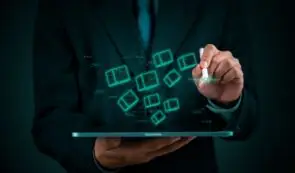 Professional business analyst interacting with digital token blocks and data visualization nodes on a tablet screen.