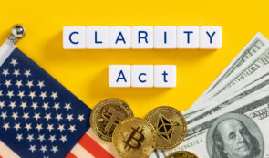 "CLARITY Act" spelled in letter tiles on a yellow background, alongside a US flag, dollar bills, and Bitcoin, Ethereum, and Tether coins.