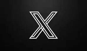 Alt: Stylized white geometric X logo centered against a dark, textured background.